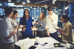 men and women working together at desk