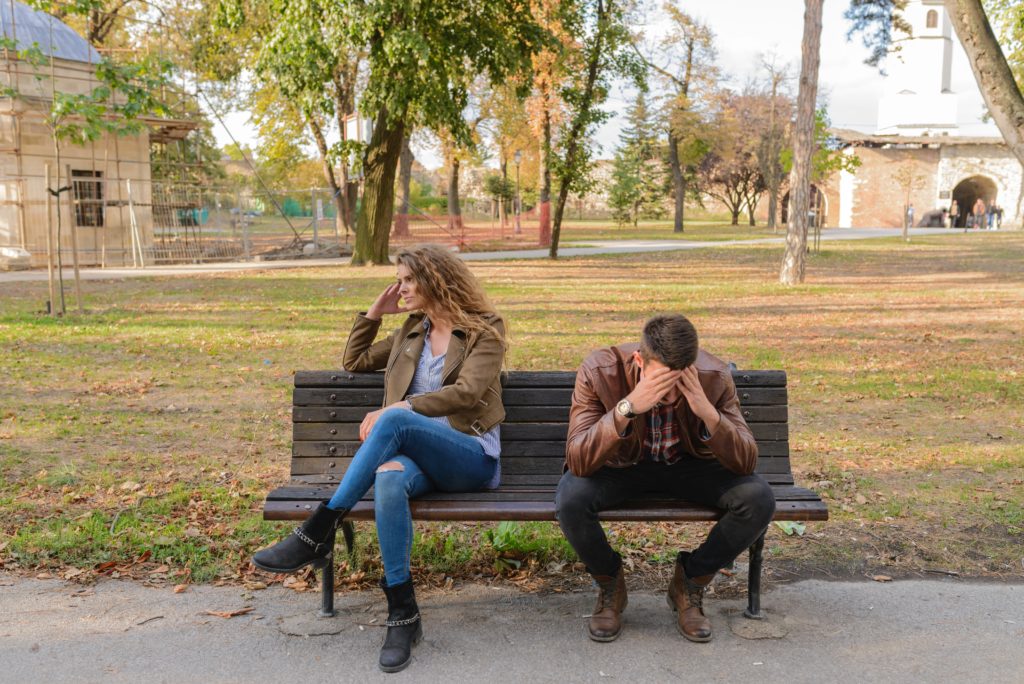 Woman and man sitting on a Nevada bench arguing.