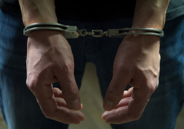man handcuffed after being arrested of heroin charges in Las Vegas
