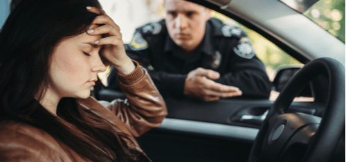 a cop talking to a female driver about traffic violation
