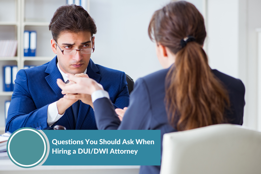 a woman asking a DUI attorney questions before hiring him