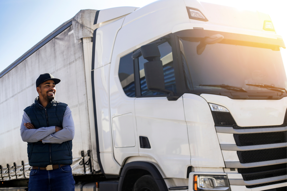 a commercial truck driver in front of his truck